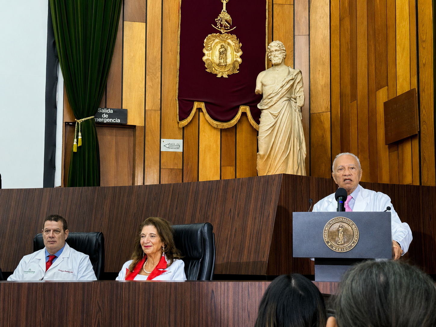Dr. Fouad Ghaly addressing fellow physicians at the National Academy of Medicine in Mexico, with Dr. Dalal Akoury seated on the panel