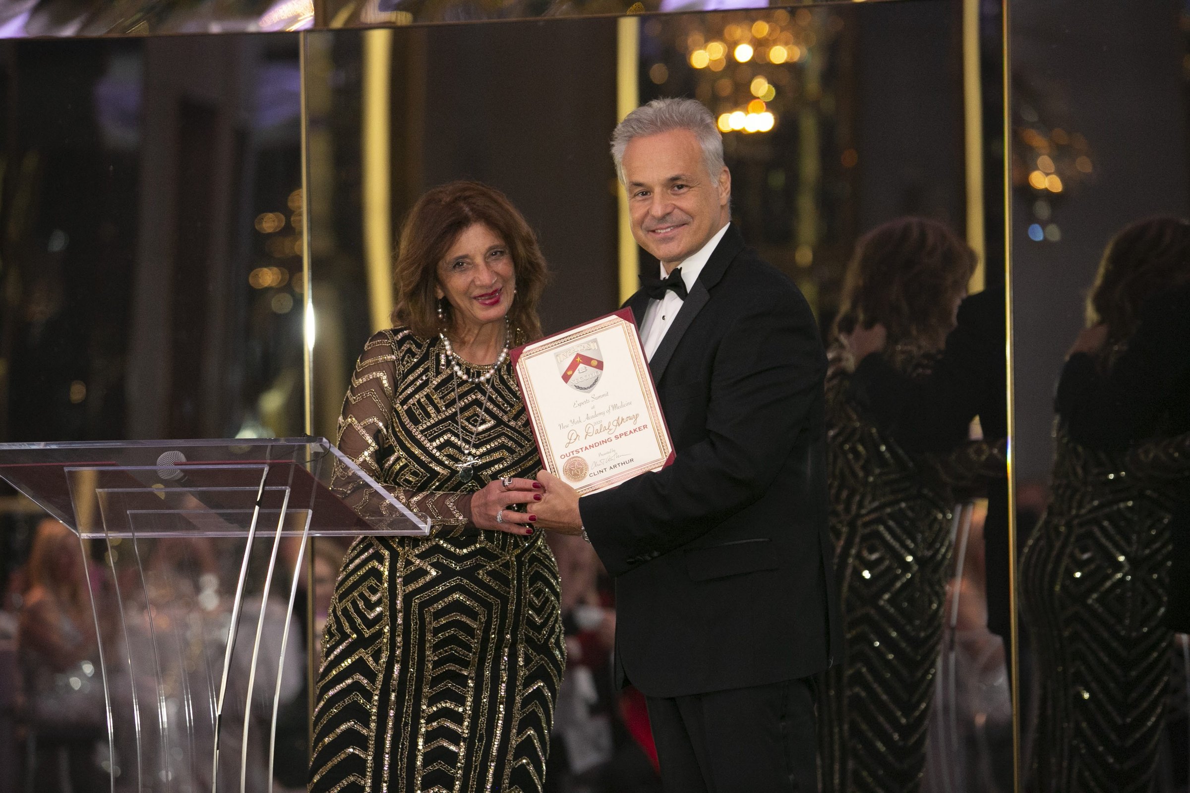 Dr. Dalal Akoury receiving an award recognizing her as an outstanding speaker at the New York Academy of Medicine